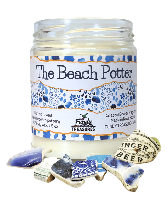 a coastal Nova Scotia candle with a piece of beach pottery embedded inside